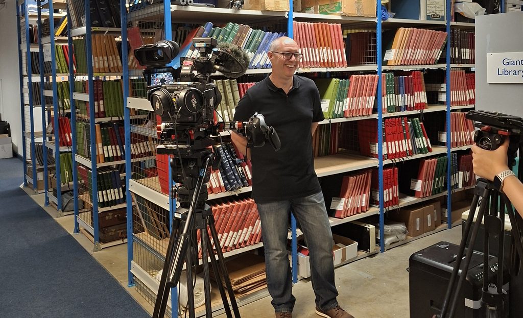 Paul smiling in front of a camera